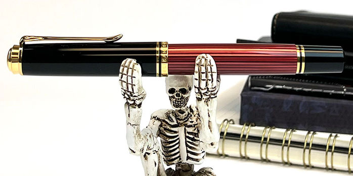 pelikan_souveran_m800_black_red_fountain_pen_with_skeleton_pen_holder_closeup