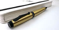 monteverde_invincia_brass_ballpoint_pen_beside_white_notebook
