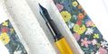 conklin_herringbone_yellow_fountain_pen_showing_nib_against_flowers