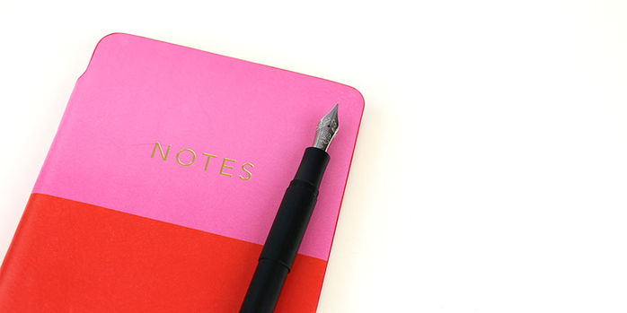 kaweco_supra_black_fountain_pen_on_pink_red_notebook