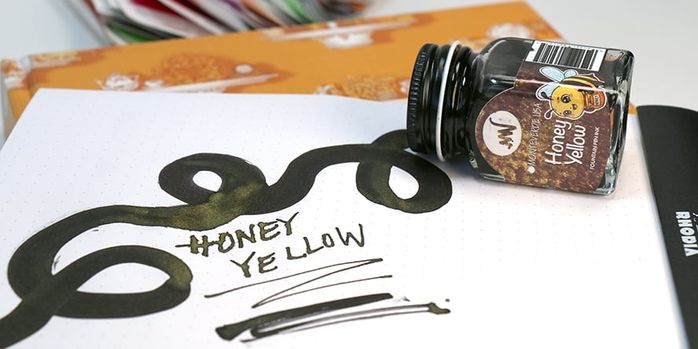 monteverde_honey_yellow_30ml_ink_swatch_and_writing_sample_in_notebook