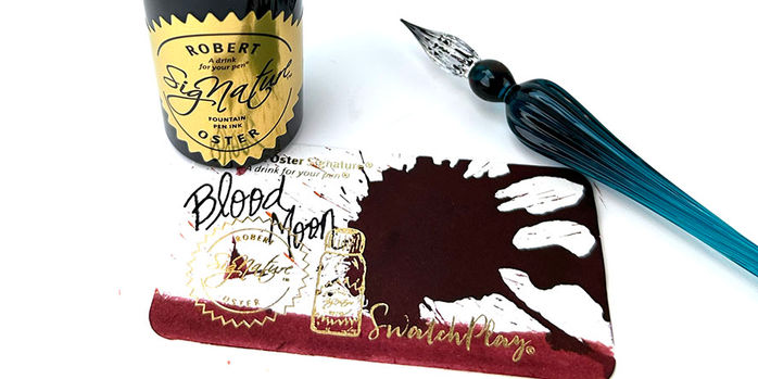 robert_oster_signature_blood_moon_ink_swatch_and_writing_sample_with_ink_bottle_and_dip_pen