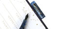 opus_88_koloro_demonstrator_sapphire_fountain_pen_uncapped_on_notepad