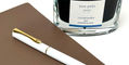diplomat_traveller_white_fountain_pen_with_gold_trim_and_pineider_blues_notebook