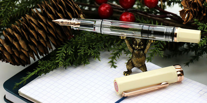 twsbi_eco_creme_rose_gold_fountain_pen_on_sassy_brassy_cat_pen_rest_with_christmas_garland
