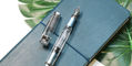 twsbi_diamond_580al_iceberg_blue_fountain_pen_uncapped_on_notebook
