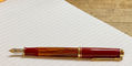 pelikan_m600_tortoiseshell_red_fountain_pen_on_lined_paper