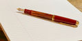 pelikan_m600_tortoiseshell_red_fountain_pen_posted_on_lined_paper