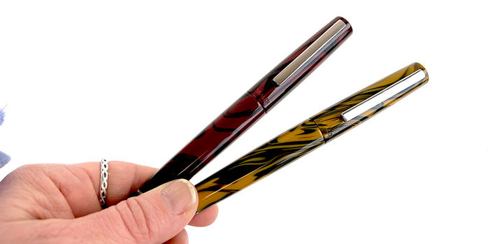 tibaldi_infrangibile_all_chrome_yellow_and_all_mauve_red_fountain_pens_in_hand