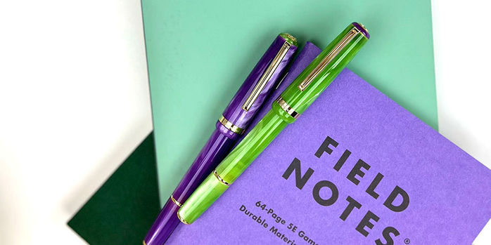 esterbrook_jr_pocket_paradise_fountain_pens_purple_passion_and_key_lime_capped_on_field_notes_gaming_journals