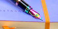 monteverde_20th_anniversary_innova_carbon_and_rainbow_nib_on_rhodia
