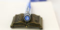 retro_51_usps_sailboat_2023_tornado_rollerball_pen_finial_on_sepia_listen_to_your_heart_pen_rest