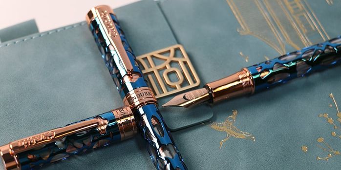 conklin_endura_deco_crest_demo_blue_rose_gold_fountain_pen_on_notebook