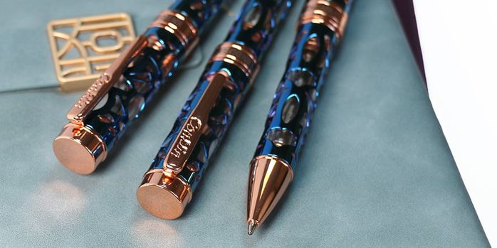 conklin_endura_deco_crest_demo_blue_rose_gold_ballpoint_pen_on_notebook