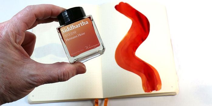 Wearingeul_world_lit_siddhartha_ink_bottle_in_hand_above_ink_swatch