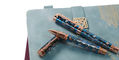 conklin_endura_deco_crest_demo_blue_rose_gold_rollerball_on_notebook