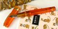 visconti_kaleido_fire_opal_fountain_pen_uncapped_on_tiger_notebook