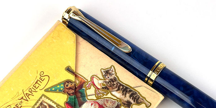 pelikan_m800_blue_o_blue_fountain_pen_capped_by_notebook