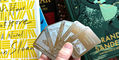 wearingeul_edge_bookmarks_in_hand_with_brandon_sanderson_book