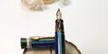 delta_indigenous_people_sentinelesi_fountain_pen_uncapped_on_wood