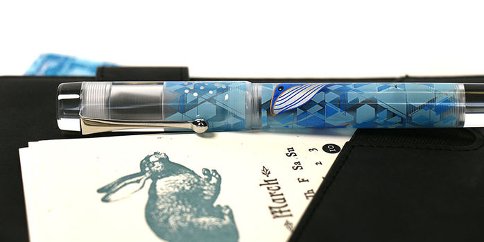 opus_88_blue_whale_fountain_pens_capped_against_black_notebook