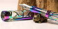sweet_and_sassy_brassy_cat_pen_rests_curious_from_side