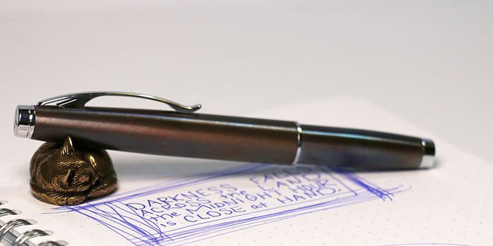 monteverde_dakota_raw_flame_fountain_pen_capped_on_sweet_and_sassy_brassy_cat_pen_rest
