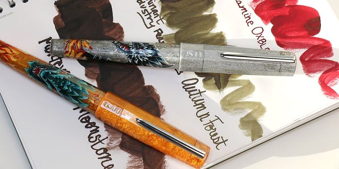 benu_limited_edition_dragon_euphoria_fountain_pens_capped_on_notebook