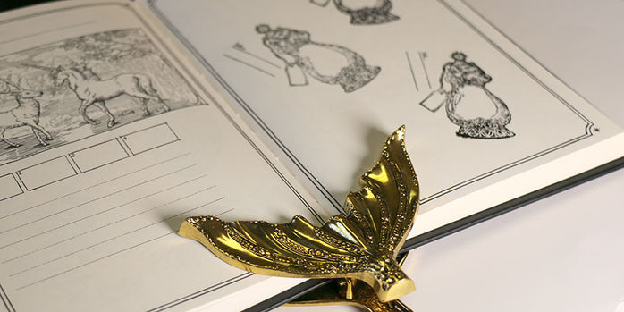 brass_page_holder_mermaid_tail_with_log_of_elixir_wood_stamp