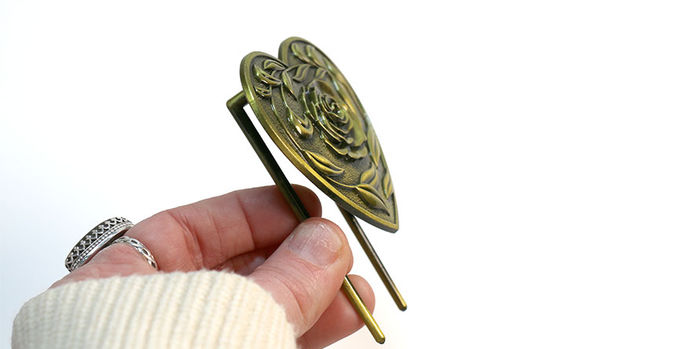 brass_page_holders_lovestruck_bookmark_in_hand_from_side