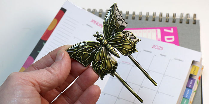 brass_page_holders_old_school_swallowtail_in_hand