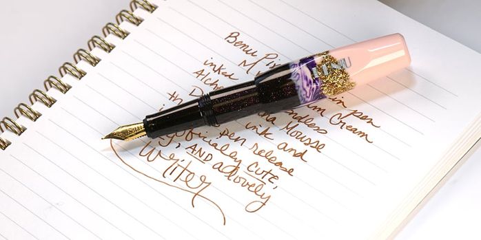 benu_pixie_plum_cream_writing_sample_in_notebook