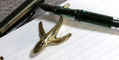 sassy_brassy_whale_pen_rest_with_monteverde_mp1_fountain_pen_on_lined_notebook
