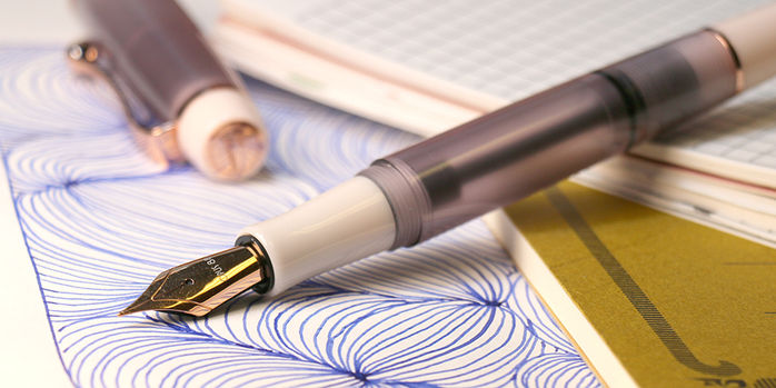 opus_88_2025_harmony_fountain_pen_uncapped_on_notebook_with_drawing
