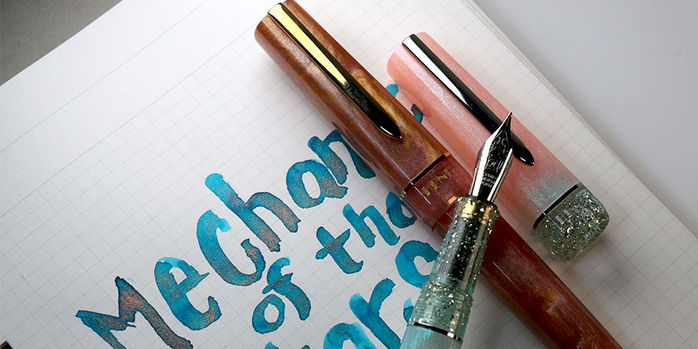 benu_haute_collection_fountain_pens_lustre_and_perle_with_ferris_wheel_press_mechanics_of_the_stars_ink_swatch