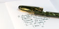 wearingeul_reservoir_thread_b6_notebooks_writing_sample_on_blank_grey_notebook_with_penlux_delgado_moss_m_nib