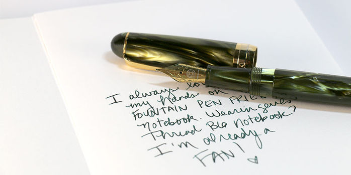 wearingeul_reservoir_thread_b6_notebooks_writing_sample_on_blank_grey_notebook_with_penlux_delgado_moss_m_nib