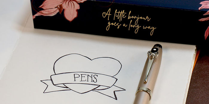 sheaffer_emily_in_paris_100_rollerball_pen_capped_on_notebook
