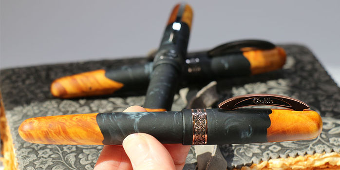 conklin_1898_exclusive_spectra_fusion_night_ember_rollerball_pens_holding_rose_gold
