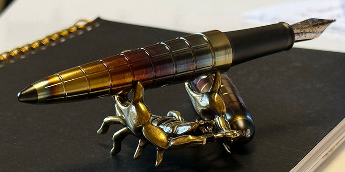 sassy_brassy_scorpion_pen_rest_with_diplomat_aero_rhomb_flame_fountain_pen
