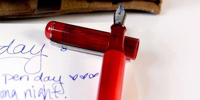 tom_hessin_exhibition_red_fountain_pen_b_nib_inked_with_platinum_pigment_blue_ink_nib_on_cap