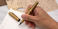 conklin_mark_twain_brass_chased_fountain_pens_in_hand